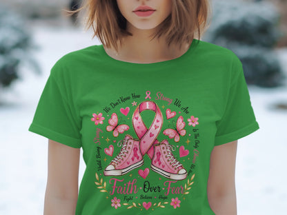 Green t-shirt with pink ribbon, sneakers, butterflies, and text "Faith Over Fear".