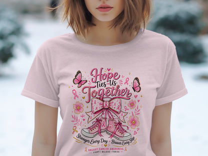 Pink t-shirt with "Hope Ties Us Together" breast cancer awareness design.