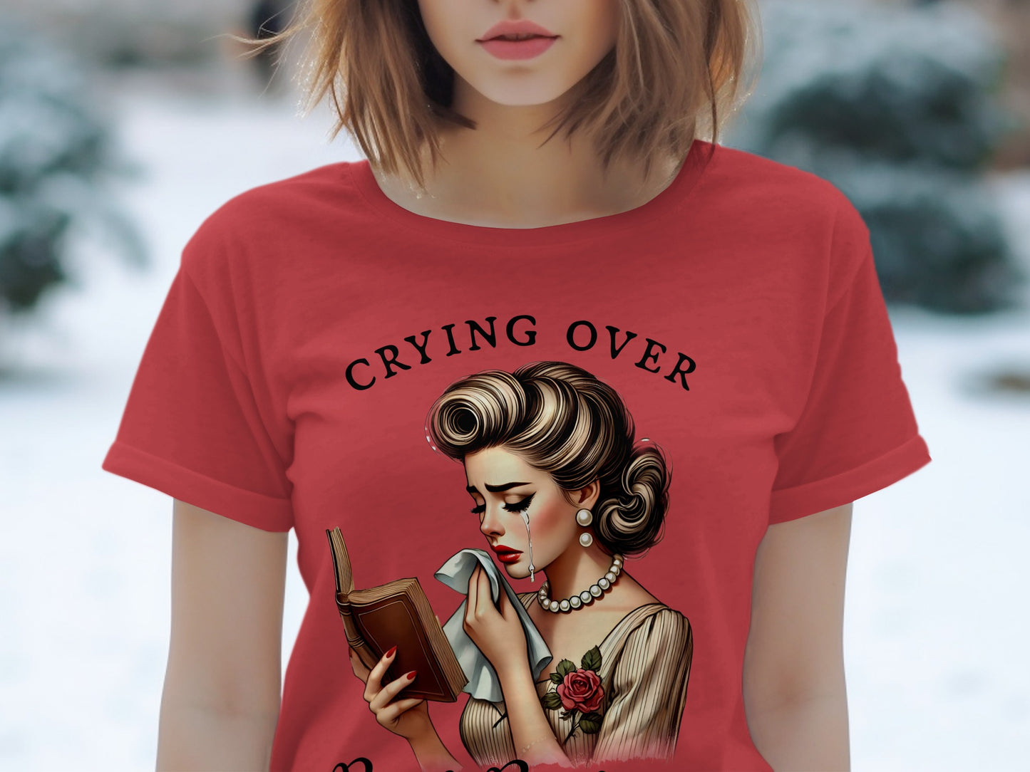 Red t-shirt with vintage illustration of woman crying over a book, text "CRYING OVER".