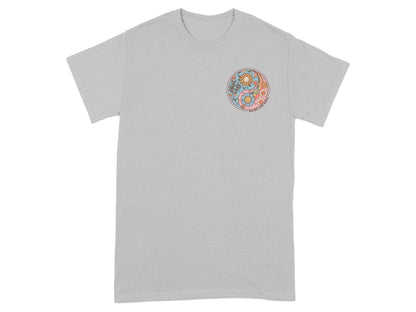 Gray t-shirt with a circular yin-yang design featuring flowers and smiling suns.
