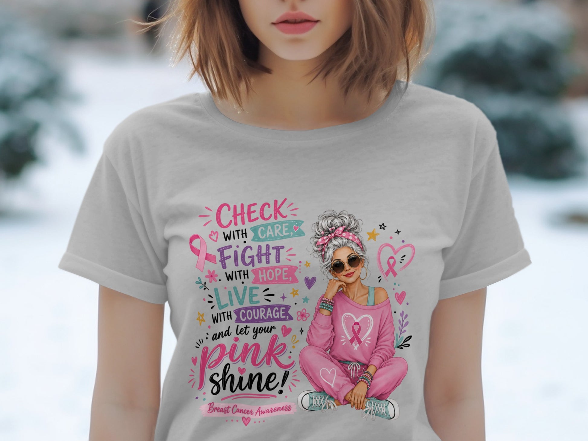 Grey t-shirt graphic with text about checking with care, fighting with hope, living with courage, and letting pink shine.