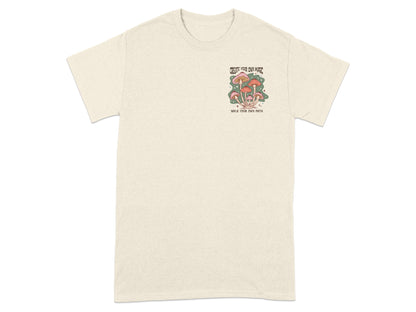 Cream t-shirt with a mushroom graphic and text "Create Your Own Magic" and "Walk Your Own Path".