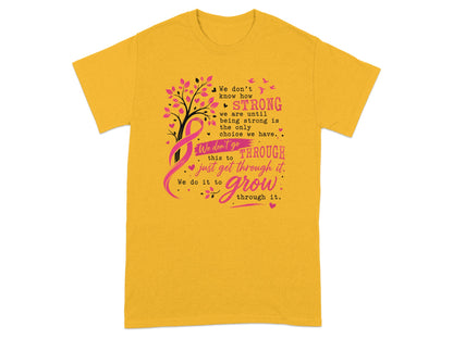 Yellow t-shirt with pink ribbon, tree, and text about strength and growth.