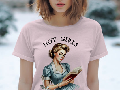 Pink t-shirt with "HOT GIRLS" text and vintage woman reading book graphic.