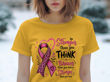 Yellow t-shirt with pink ribbon and text "Stronger than you THINK Braver than you believe Stronger than you seem."