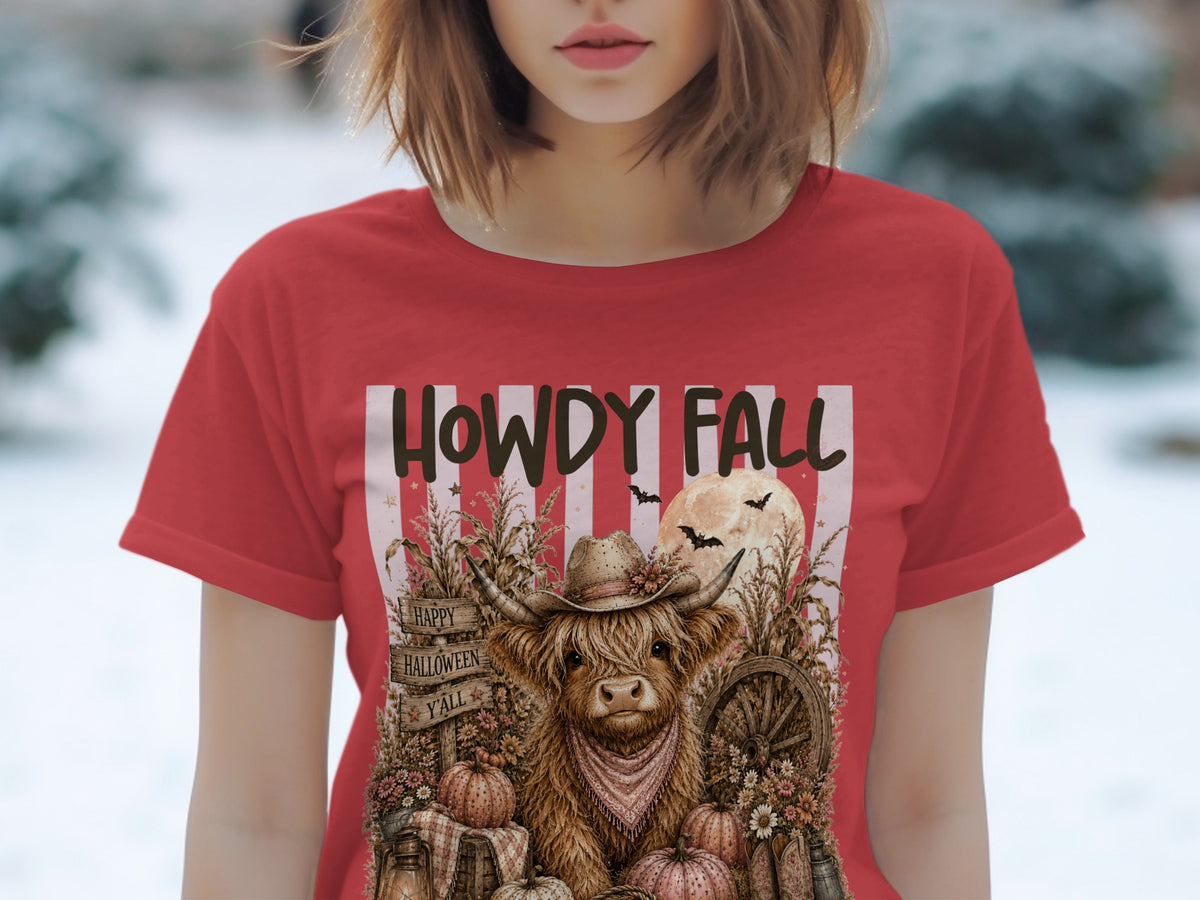 Red t-shirt with highland cow, pumpkins, "Howdy Fall" and "Happy Halloween Y'all" text.