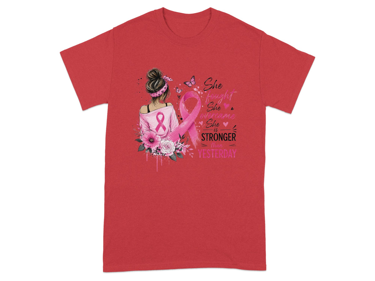Red t-shirt with pink breast cancer ribbon and text "She fought, she overcame, she is stronger than yesterday."
