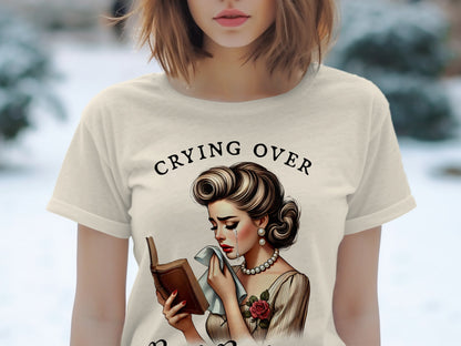 Cream t-shirt with "Crying Over" text and vintage distressed woman with book.