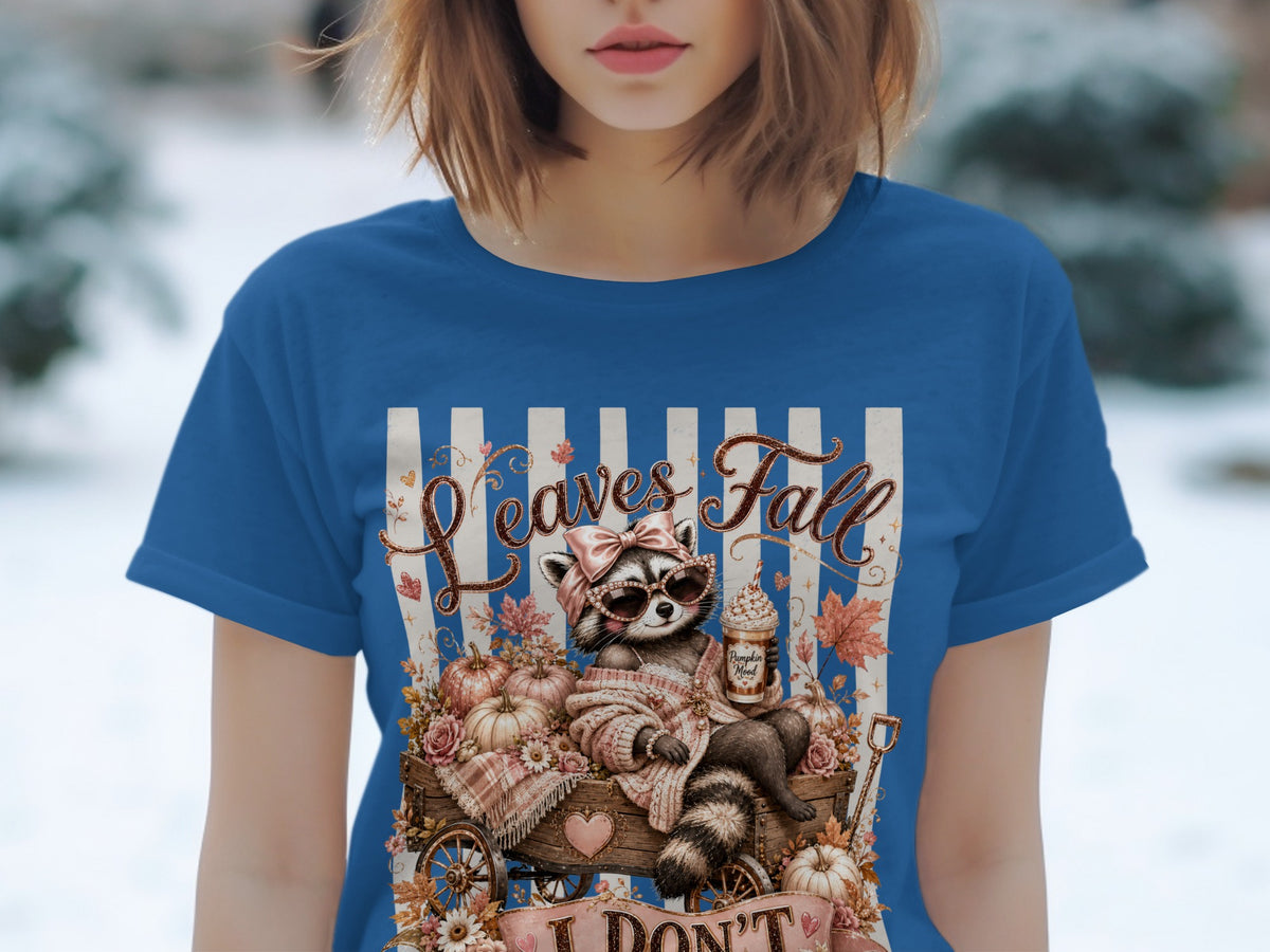 Raccoon in cart with pumpkins and text "Leaves Fall".