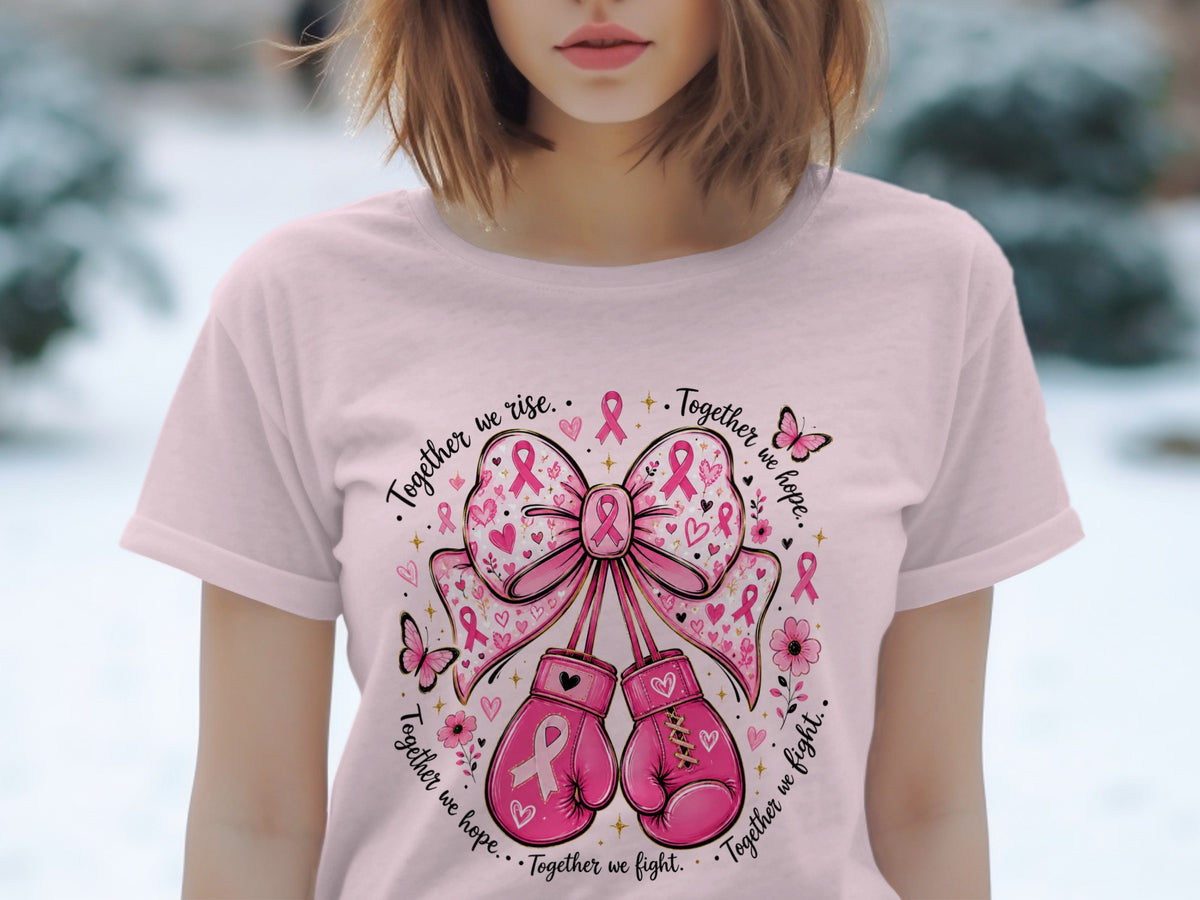 Pink t-shirt with a graphic of boxing gloves, bows, and butterflies with breast cancer ribbons.