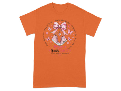 Pink sneakers and a bow with breast cancer ribbons and butterflies on an orange shirt.