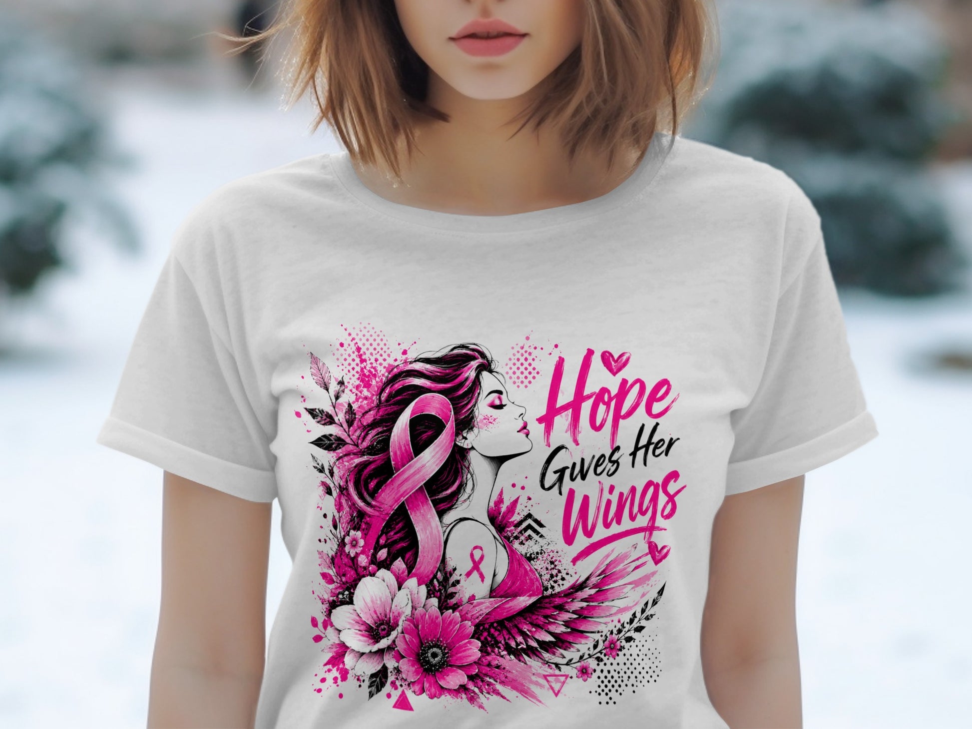 White t-shirt with pink design: woman with breast cancer ribbon, flowers, wings, and text.