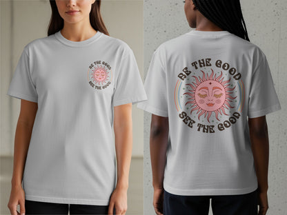 Grey t-shirt with a pink sun graphic and text "BE THE GOOD SEE THE GOOD."