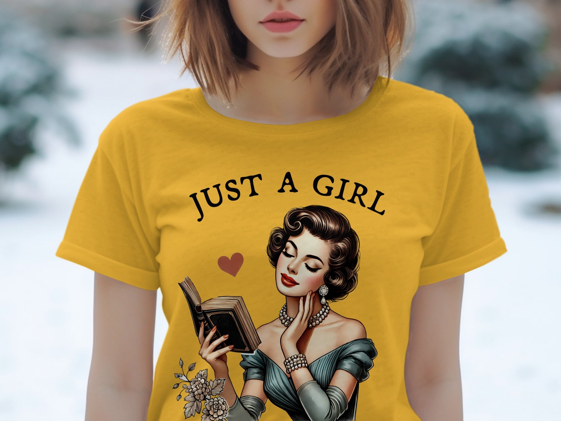 Yellow t-shirt with "JUST A GIRL" text and a vintage illustration of a woman reading.