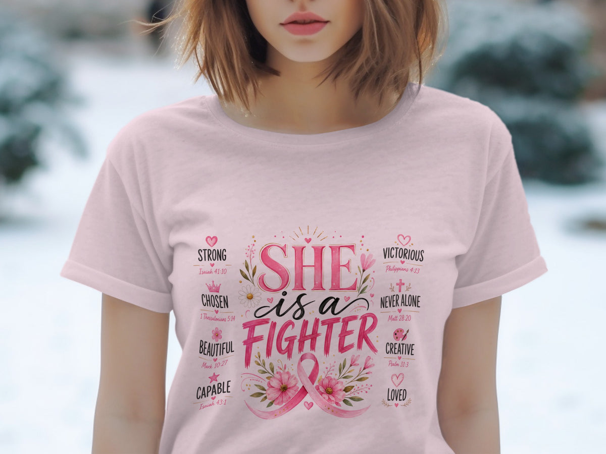 Pink t-shirt with "SHE is a FIGHTER" text and breast cancer ribbon.