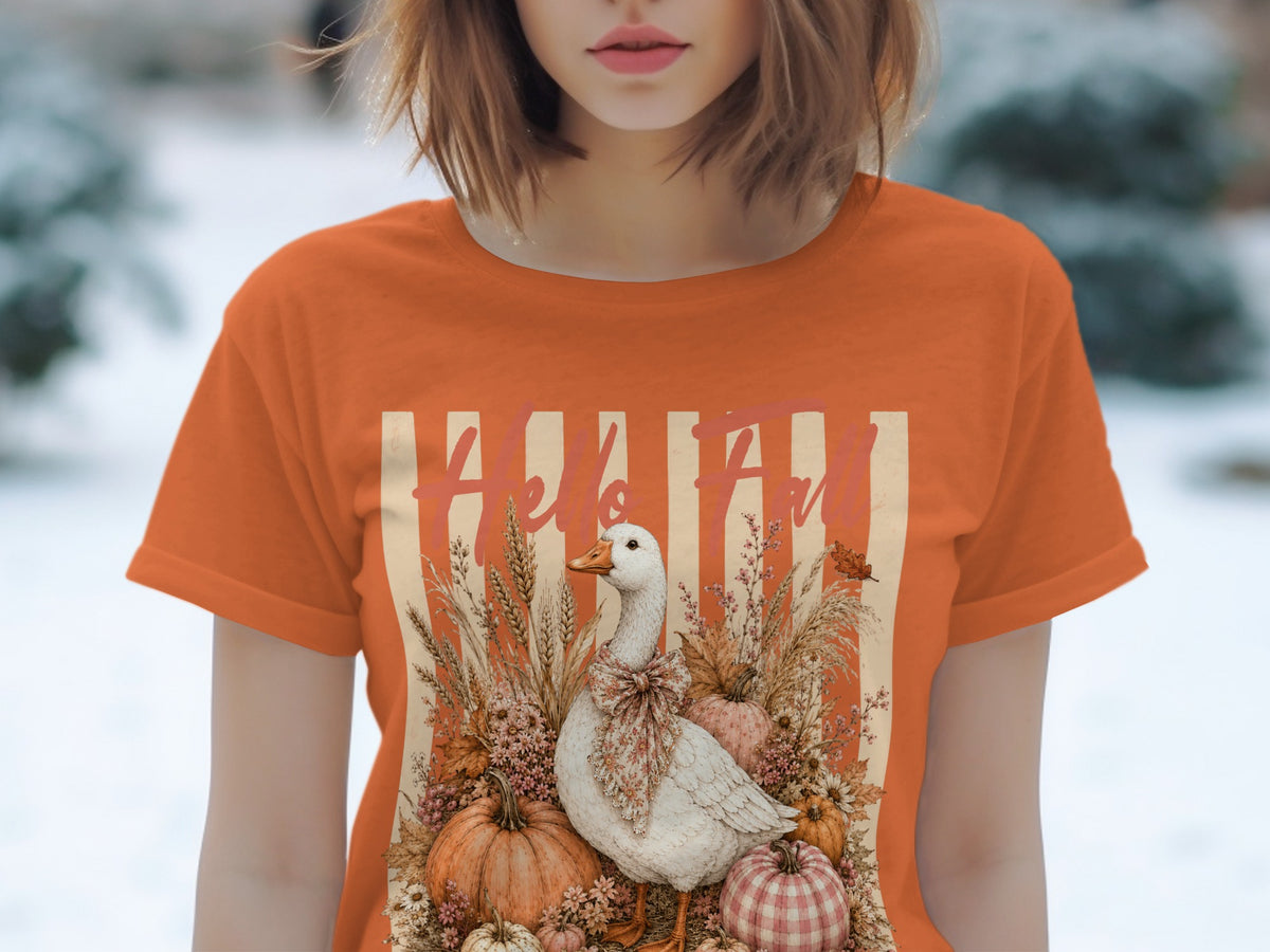 White goose with bow surrounded by pumpkins and fall foliage, text reads "Hello Fall".