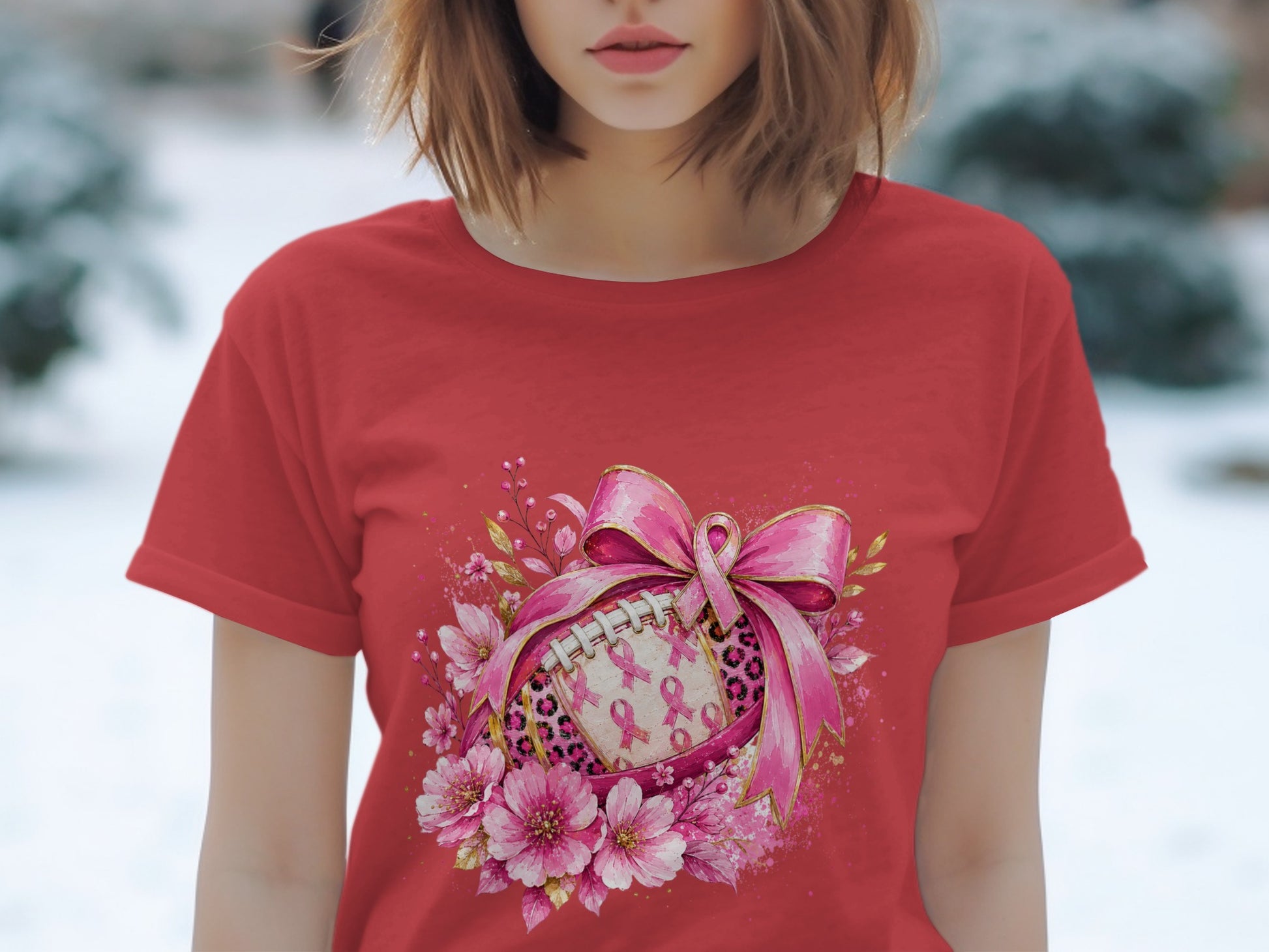 Red t-shirt with a graphic of a football adorned with pink ribbons and flowers.