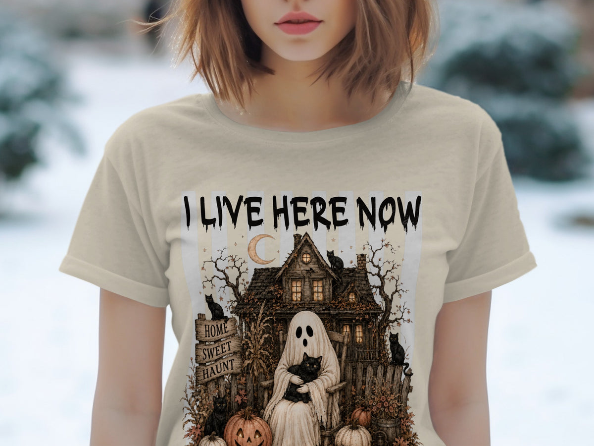 T-shirt with "I LIVE HERE NOW" and a haunted house graphic with a ghost and black cats.
