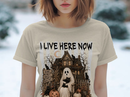 T-shirt with "I LIVE HERE NOW" and a haunted house graphic with a ghost and black cats.