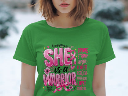 Green t-shirt with pink text "SHE is a WARRIOR" and supportive words.