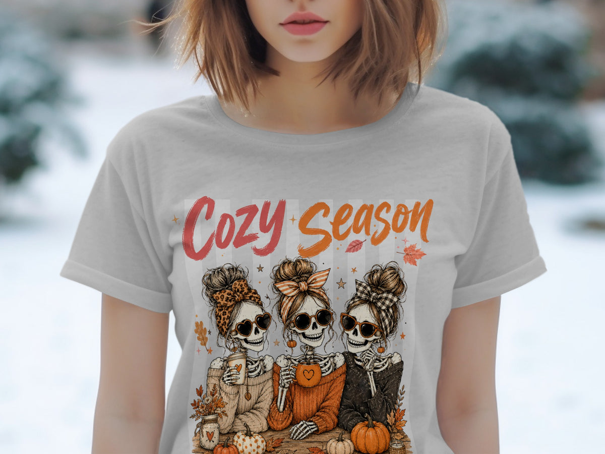 Three skeletons in sunglasses and messy buns celebrate "Cozy Season" with pumpkins.