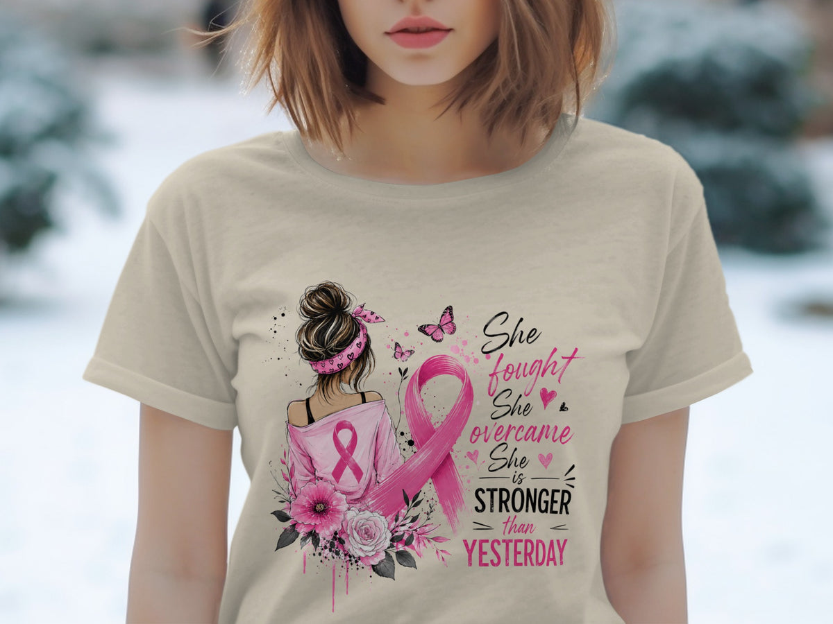 T-shirt with pink ribbon, flowers, and text "She fought She overcame She is STRONGER than YESTERDAY".