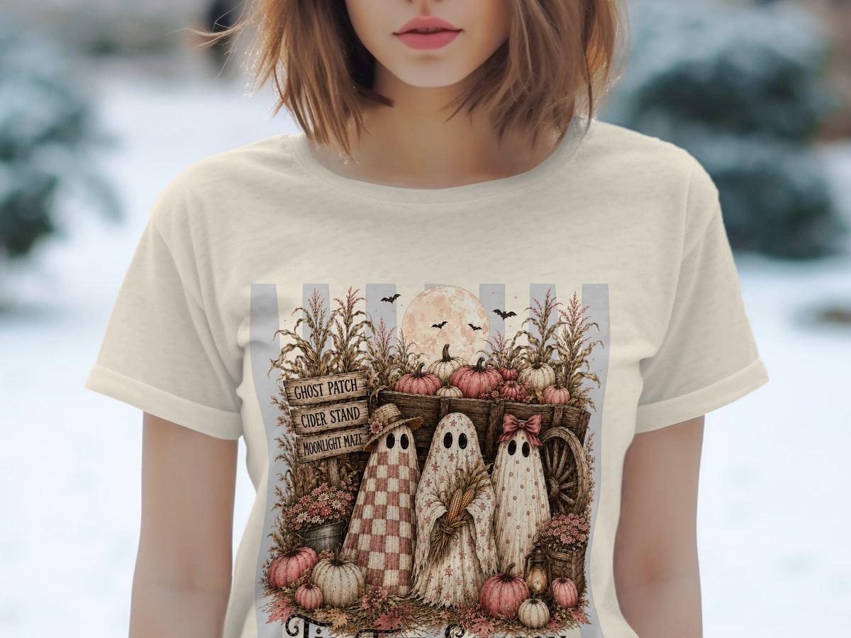 Three ghosts stand by a wagon with pumpkins, corn stalks, and a sign reading "Ghost Patch Cider Stand Moonlight Maze."