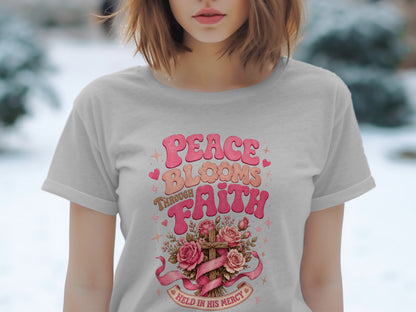 Grey t-shirt with "Peace Blooms Through Faith" graphic and a cross with roses.