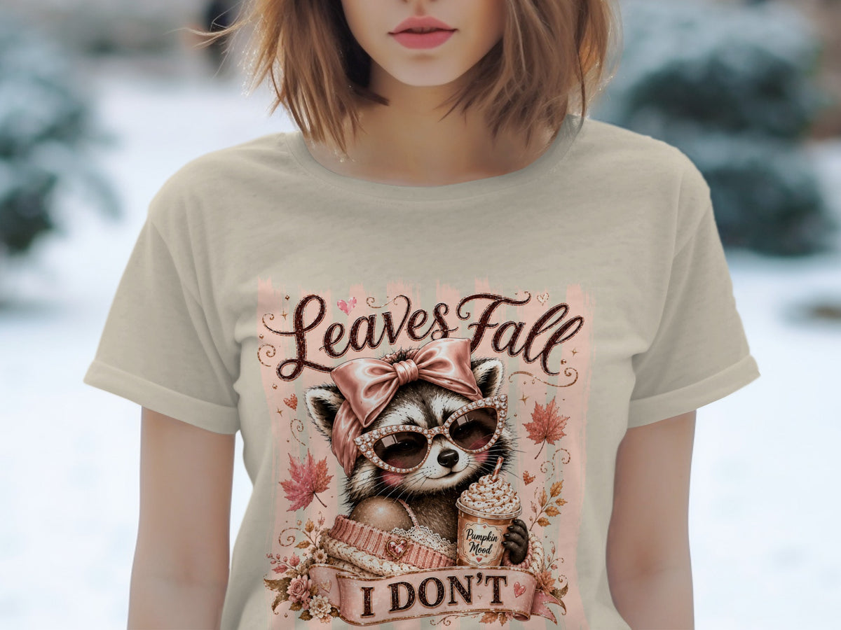 Raccoon wearing sunglasses and holding a pumpkin spice drink with "Leaves Fall" and "I DON'T" text.
