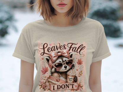 Raccoon wearing sunglasses and holding a pumpkin spice drink with "Leaves Fall" and "I DON'T" text.