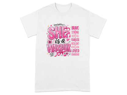 White t-shirt with "SHE is a WARRIOR" and breast cancer awareness ribbon.