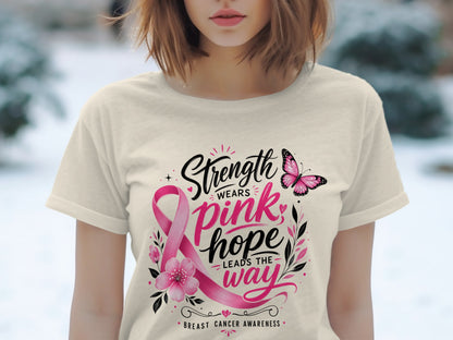 Cream t-shirt with pink ribbon, butterfly, and text "Strength wears pink; hope leads the way; Breast Cancer Awareness."