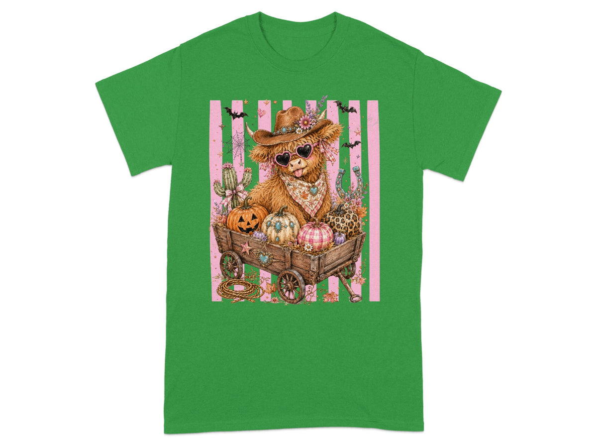 Highland cow in wagon with pumpkins, bats, and cacti on pink striped background.