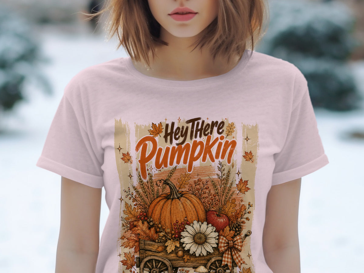Pink t-shirt with "Hey There Pumpkin" text and autumn harvest cart graphic.