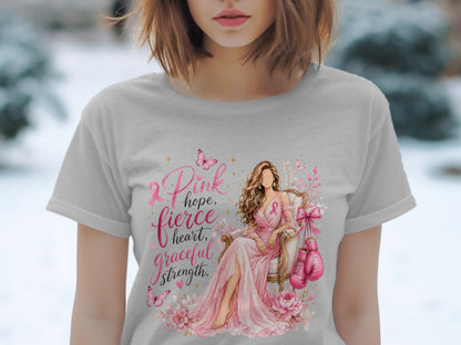 T-shirt graphic: woman in pink dress, boxing gloves, text "Pink hope, fierce heart, graceful strength".