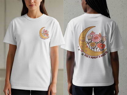 White t-shirt with crescent moon, flowers, and "take a moment to breathe" text.