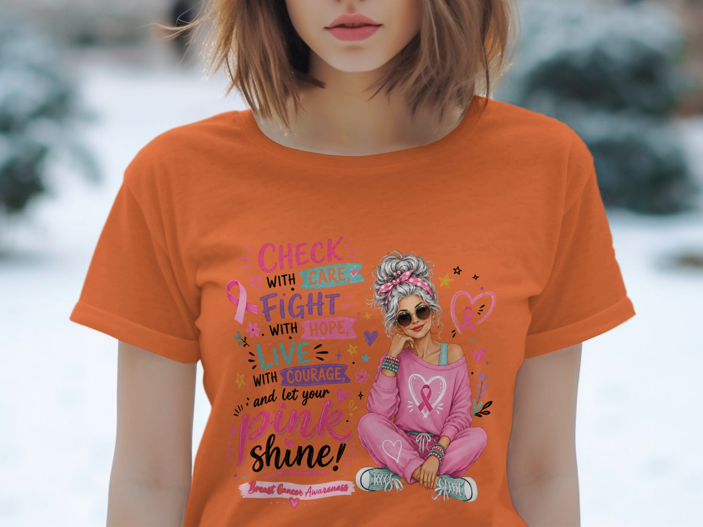 Orange t-shirt with "Check with Care, Fight with Hope, Live with Courage, and let your Pink Shine!"