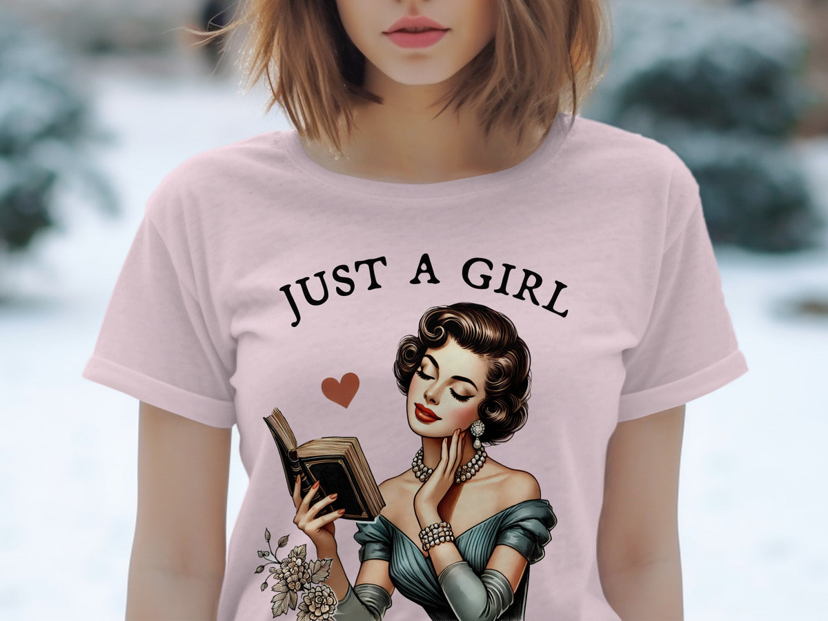 Pink t-shirt with "Just a girl" and illustration of a woman reading a book.