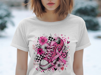 Pink sneaker with breast cancer ribbon surrounded by flowers and hearts.