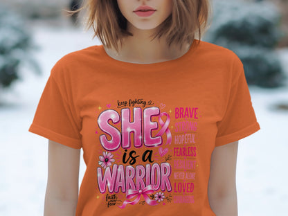 Orange t-shirt with "SHE is a WARRIOR" and empowering words.