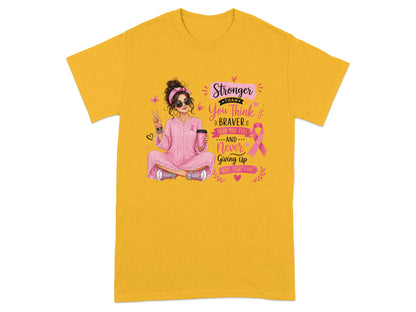 Yellow t-shirt with woman, pink ribbon, and text: Stronger than you think, braver than you feel, never giving up.