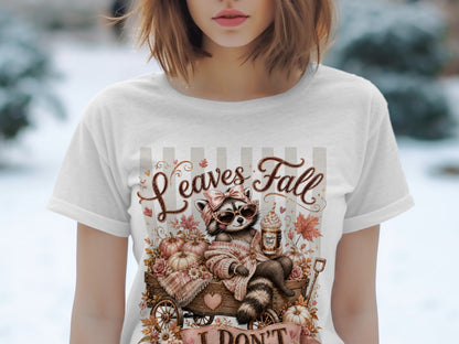 T-shirt with raccoon in wagon, pumpkins, and "Leaves Fall" text.