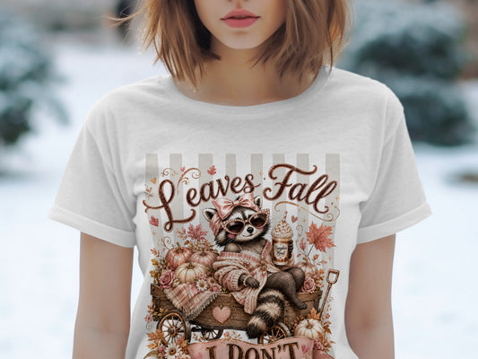 T-shirt with raccoon in wagon, pumpkins, and "Leaves Fall" text.
