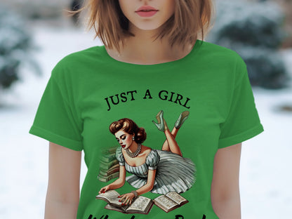 Green t-shirt with "Just a Girl" text and vintage woman reading books graphic.