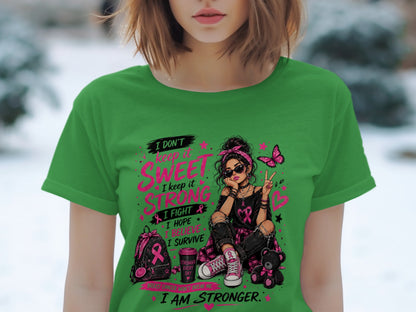 Green t-shirt with graphic of a woman, pink butterfly, and text about strength.