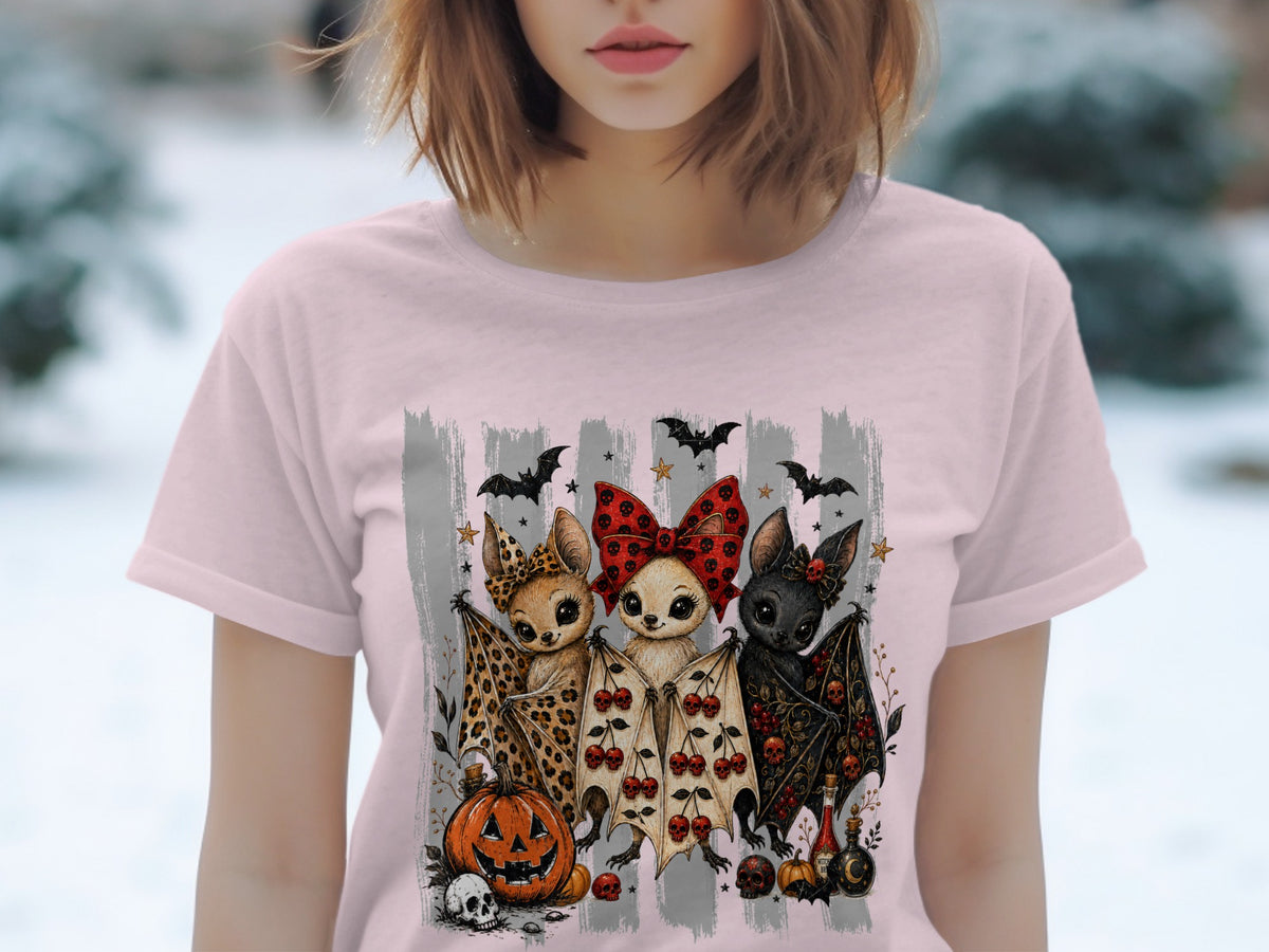 Three cartoon bats with Halloween-themed outfits and accessories, next to pumpkins and skulls.