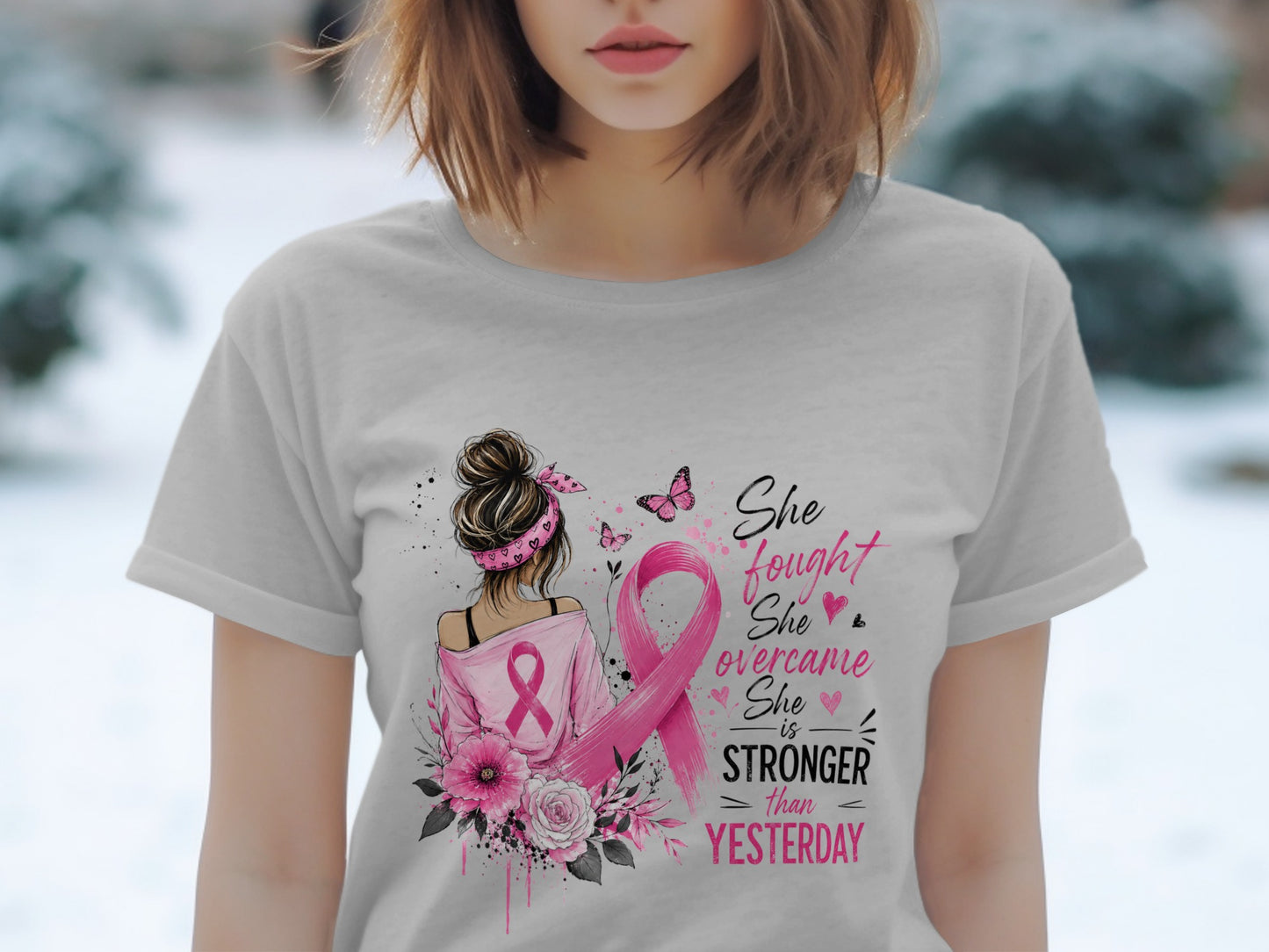 T-shirt with pink ribbon art, butterflies, flowers, and text: "She fought, She overcame, She is STRONGER than YESTERDAY."