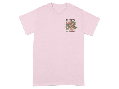 Pink t-shirt with a mushroom graphic and text "Create your own magic, walk your own path."