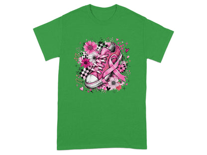 Pink sneaker with breast cancer ribbon and floral design on green t-shirt.