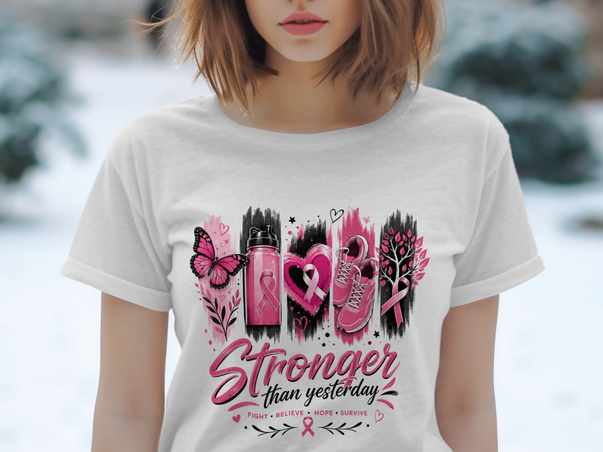 White t-shirt with "Stronger than yesterday" graphic and breast cancer awareness symbols.